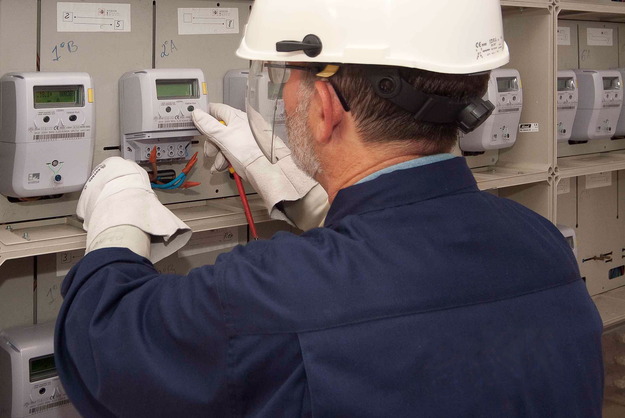 Operario trabajando con un equipo de medida en una centralización de contadores